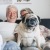 a person and a dog sitting on a couch
