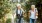 a man and woman walking on a path with hiking gear