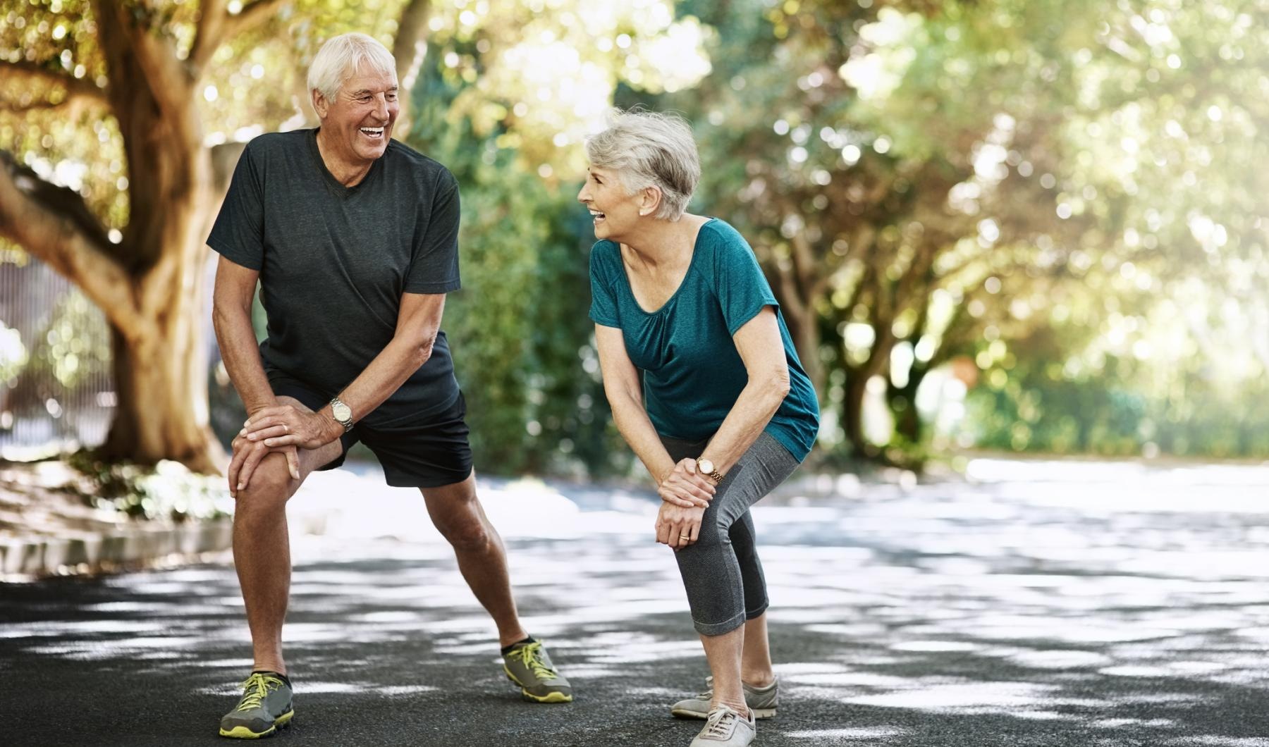 a man and a woman running on a road